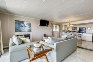 a living room with two couches and a kitchen at Ocean One in Ocean City
