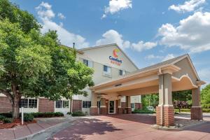 a front view of a hotel with a building at Comfort Suites Fort Collins Near University in Fort Collins