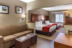 a hotel room with two beds and a couch at Comfort Suites Fort Collins Near University in Fort Collins +41 photos