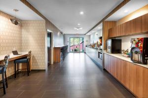 a kitchen with a long hallway with a counter and a table at Microtel Inn & Suites by Wyndham Warsaw in Warsaw