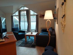 ein Wohnzimmer mit einem Sofa und einem Tisch in der Unterkunft Dünenpark Binz - Komfort Ferienwohnung mit 1 Schlafzimmer und Balkon im Dachgeschoss 282 in Binz