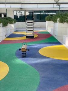 a playground with a teddy bear sitting on a swing at Mayan, Yas Island in Abu Dhabi