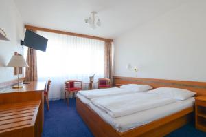 Postel nebo postele na pokoji v ubytování Hotel ILF