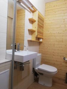 a bathroom with a white sink and a toilet at Poilsis Jums in Nida