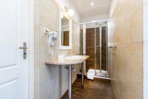 a bathroom with a sink and a shower at Willa Excelsior in Zakopane +53 photos