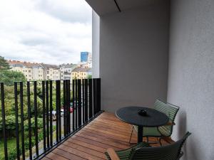 a balcony with a table and chairs and a view at limehome Linz Schillerstraße in Linz