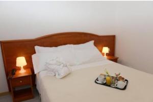A bed or beds in a room at Buon Hotel Bologna Centro - Affittacamere - Self Check-In