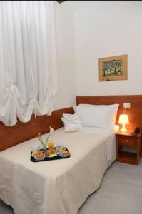 A bed or beds in a room at Buon Hotel Bologna Centro - Affittacamere - Self Check-In