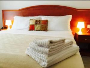 a bedroom with a bed with white towels on it at Buon Hotel Bologna Centro - Affittacamere - Self Check-In in Bologna