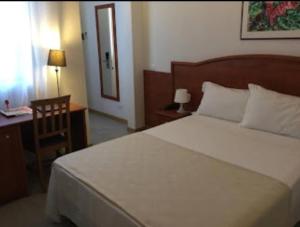 A bed or beds in a room at Buon Hotel Bologna Centro - Affittacamere - Self Check-In