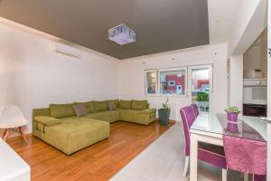a living room with a couch and a table at Apartment Mario in Strožanac