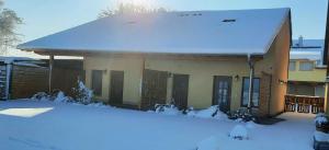a house with snow on top of it at Ferienwohnung Schoch in Rust