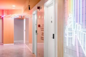 a hallway with a door and a colorful wall at Bob W Chueca in Madrid