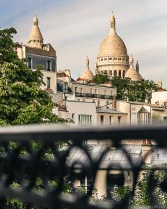a view of a city with domes on a building at Timhotel Montmartre in Paris