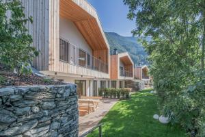 an exterior view of a building with a stone wall at Chalet & Appartement Zingerlehof Trens in Campo di Trens