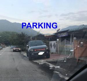 a truck parked on the side of a street at Kinaz homestay in Ipoh