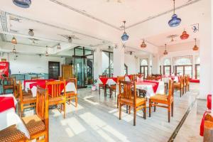 a dining room with wooden tables and chairs at Hotel Pichola Haveli in Udaipur