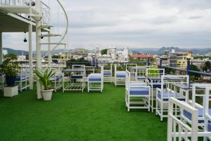 a group of chairs and tables on a roof at Hotel Pichola Haveli in Udaipur