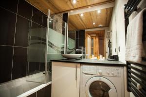 a laundry room with a washing machine and a sink at Apartment Blaitiere - luxurious 2 bed apartment in Chamonix