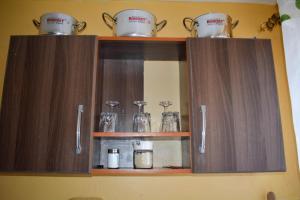 a cabinet with pots and pans on top of it at Fika Casa in Nakuru