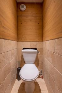 a bathroom with a toilet in a room with wooden walls at Val Thorens-Cosy Lauzières 315 in Val Thorens