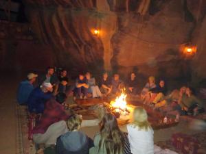 a group of people sitting around a fire at Rum Panoramic Camp & Tour in Wadi Rum