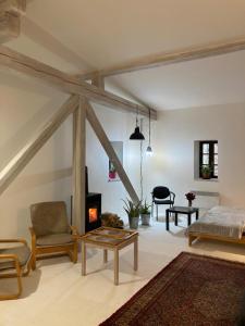 a living room with a bed and a fireplace at PENZION PIVOVAR - Jedinečné ubytování v areálu bývalého pivovaru in Rudník