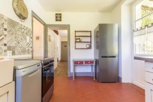 a kitchen with a refrigerator and a table in it at Les Barboulottes in Châtillon-en-Bazois +13 photos
