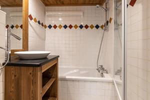 a bathroom with a sink and a bath tub at Villa Vallet- Newly renovated 2 bedroom nestled near the main street in Chamonix-Mont-Blanc