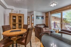 a dining room with a table and chairs at Villa Vallet- Newly renovated 2 bedroom nestled near the main street in Chamonix-Mont-Blanc
