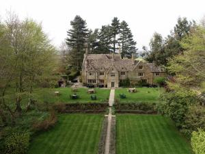 an aerial view of a large house with a yard at Charingworth Manor in Chipping Campden