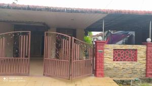 a red gate in front of a house at Aqil Homestay Lunas Kulim for Mslim only in Lunas