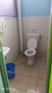 a bathroom with a toilet and a sink at Aqil Homestay Lunas Kulim for Mslim only in Lunas