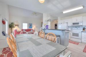 a kitchen and dining room with a table and chairs at Just Peachy in Oak Island