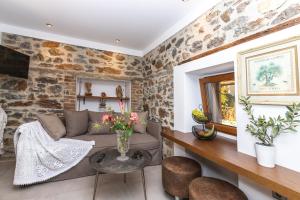 a living room with a couch and a table at Nymphes House Pefkochori in Pefkohori