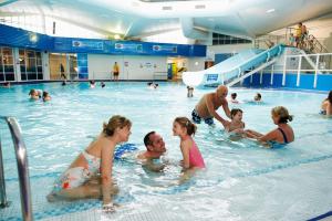 a group of people in a swimming pool at Escape City Caravan in Lytchett Minster