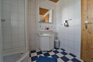 a bathroom with a sink and a toilet and a tub at BNB Claudia in Appenzell +9 photos