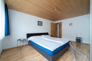 a bedroom with a bed with a wooden ceiling at BNB Claudia in Appenzell