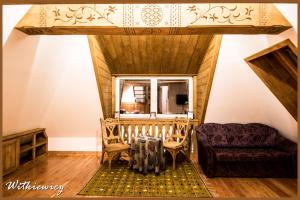 a living room with a couch and a chair at Willa Carlton in Zakopane +85 photos