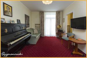 a living room with a piano and a couch at Willa Carlton in Zakopane