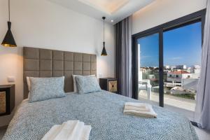 a bedroom with a bed and a large window at Correeira Luxury Residence in Albufeira +177 photos