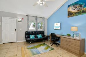 a living room with a desk and a leather chair at Latitude 26 Waterfront Resort and Marina in Fort Myers Beach