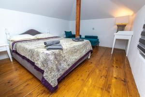 a bedroom with a bed and a wooden floor at Nymphes House Pefkochori in Pefkohori