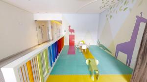 a room with a hallway with colorful floors and bookshelves at Beautiful Apartment at Carso Residential with Pool in Mexico City