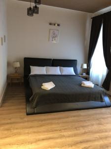 a bedroom with a bed with two pillows on it at Casa Oliver in Braşov