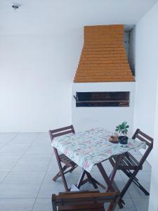 a table and two chairs in a room at Casa Yellow I Próxima a praça central in São Lourenço do Sul +8 photos