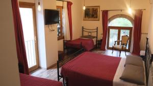 a hotel room with two beds and a tv at B&B Il Pittore in Borgo San Lorenzo +78 photos