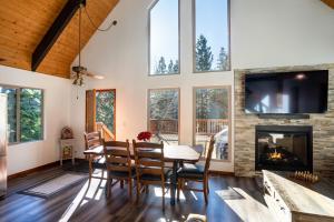 a dining room with a fireplace and a tv at North Shore - Cozy Cabin in Wood Vista