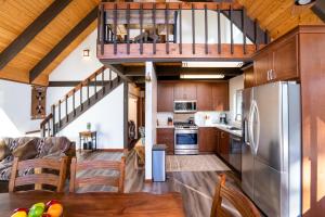 a kitchen with a staircase leading up to a loft at North Shore - Cozy Cabin in Wood Vista