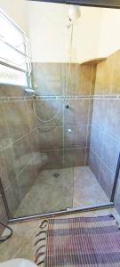 a shower with a glass door in a bathroom at Residencial Vitoria "Pé na Areia" in Ubatuba +29 photos